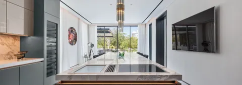 Narrow view, possibly a contemporary or open-concept kitchen with light colors.